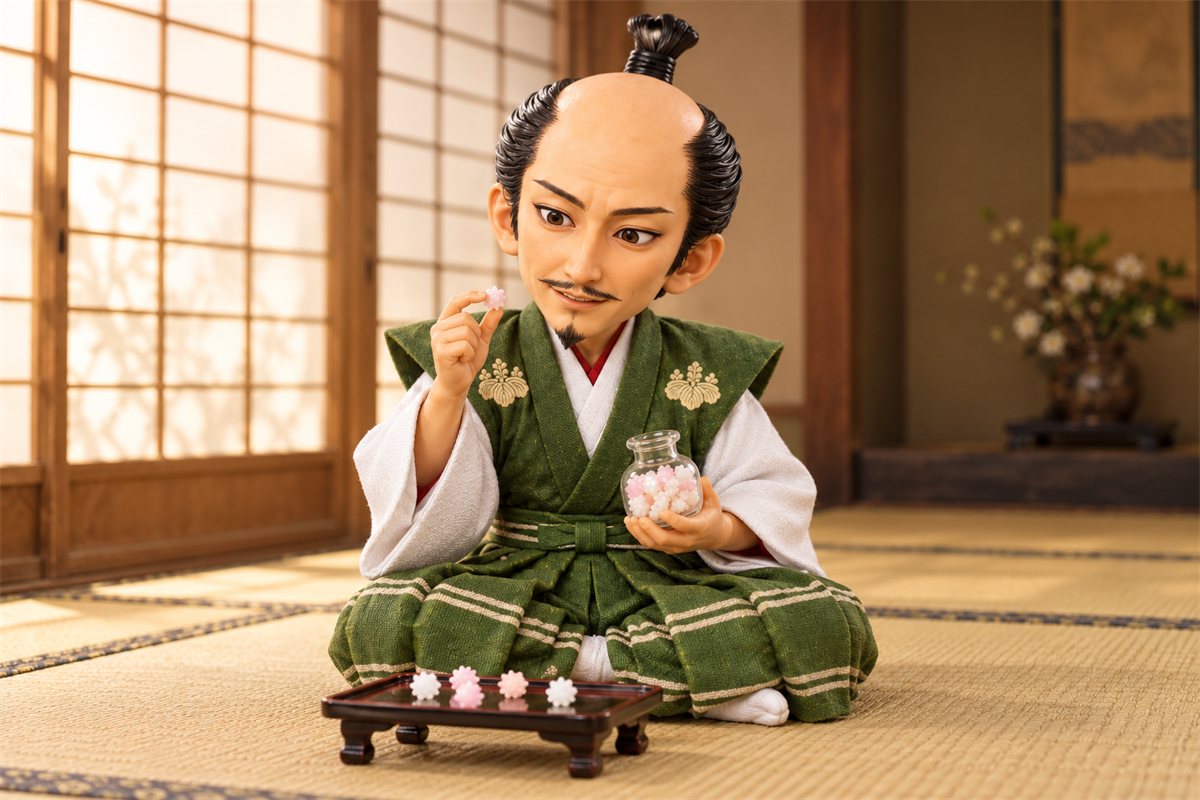 ガラスの瓶を手に、金平糖をつまんでうれしそうに見つめる織田信長のイラスト